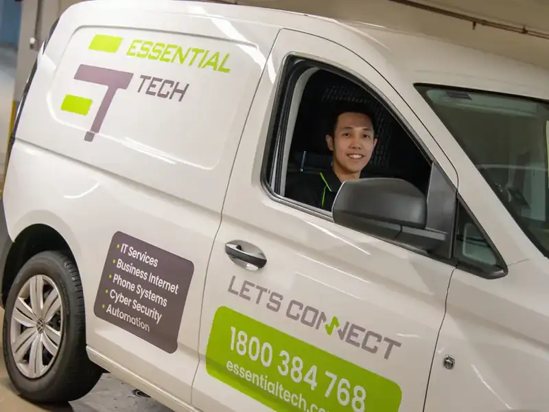 Essential Tech team member in a branded service van