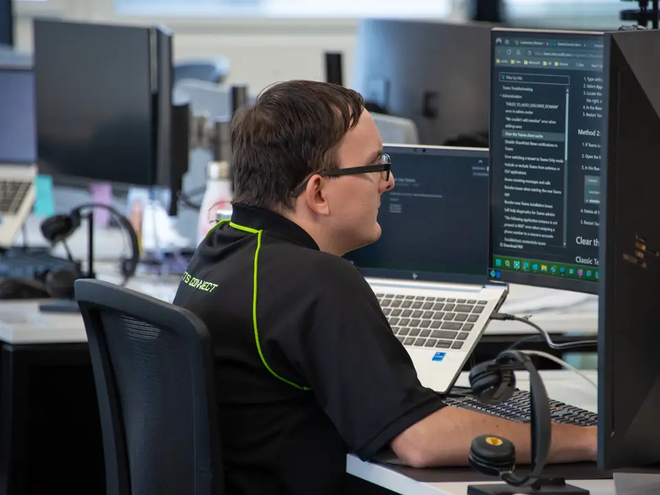 Essential Tech team member working at his desk